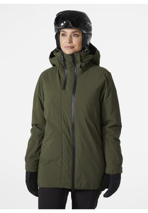 Olivgrüne Skijacke mit hohem Kragen, Reißverschluss und verstellbarer Kapuze. Verfügt über schwarze Akzente und wird mit schwarzen Handschuhen kombiniert.