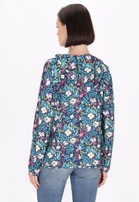 Giacca a cappuccio floreale in blu navy con motivi multicolori vivaci; presenta maniche lunghe e una vestibilità rilassata. La vista posteriore mostra i dettagli del cappuccio.