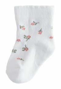 Baltos medvilninės kulkšnies kojinės su raštuota iškilmatine tekstūra, puoštos mažais rožiniais rožių žiedais ir žalių lapelių raštais visoje kojinėje.