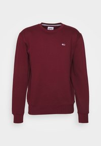 Pullover bordeaux con polsini e orlo a costine. Presenta un piccolo logo sul petto. Realizzato in morbido tessuto testurizzato. Design a girocollo.