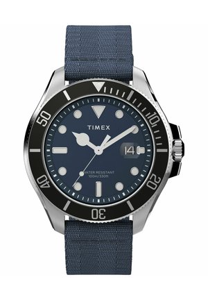 Montre Timex avec un boîtier en acier inoxydable, un bracelet en tissu bleu marine, une lunette noire et un cadran rond bleu. Résistante à l'eau jusqu'à 100 m/330 ft.
