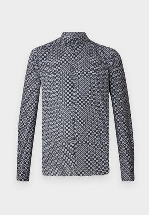 Long-sleeved button-up shirt in dark navy with a repeated white floral pattern. Features a pointed collar and front buttons. Smooth fabric texture.