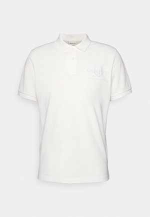 White polo shirt made of cotton, featuring a classic collar, short sleeves, and an embroidered GANT logo on the chest.