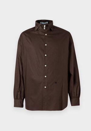 Chemise longue à manches marron en tissu lisse avec un col classique, fermeture à boutons sur le devant et poignets élastiqués ; présente un détail logo subtil.