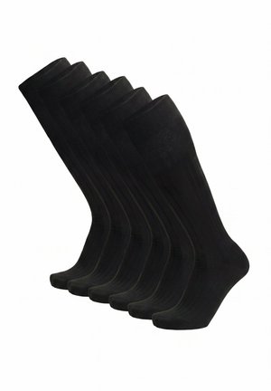 Sechs Paare schwarze, halbhohe, gerippte Socken, aufrecht vor einem weißen Hintergrund angeordnet.