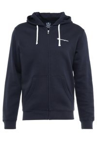 Felpa con cappuccio blu navy con zip frontale, tasca anteriore, cappuccio con coulisse e logo Champion bianco sul petto. Realizzata in tessuto morbido e resistente.