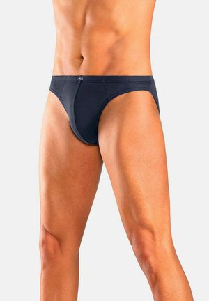 Male torso and upper legs wearing dark blue briefs against a plain light background, showing fit and style of underwear.