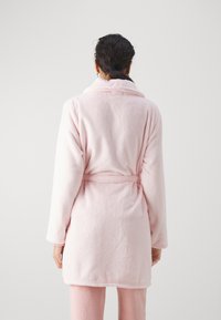 Light pink flannel bathrobe featuring a shawl collar, belted waist, and soft texture, with long sleeves and knee-length design.