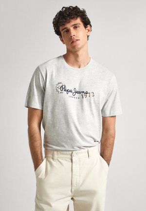 Camiseta de algodón gris con cuello redondo y mangas cortas, con "Pepe Jeans London 1973" estampado en azul oscuro y marrón.