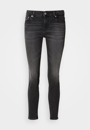 Black denim jeans with a slim fit, featuring front pockets, a button closure, and subtle fading on the thighs. Smooth texture.