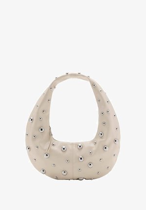 Beige leather bag with a hobo shape, featuring silver metal studs in varying sizes across the exterior, contrasting zipper closure.