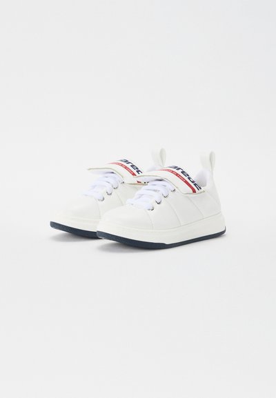 White sneakers with a smooth leather exterior, round toe, laces, and a padded tongue featuring a red and blue logo. Rubber sole with navy accents.