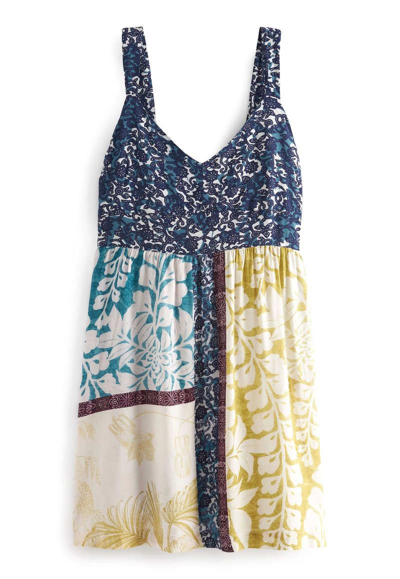 Robe sans manches avec un corsage bleu marin à motifs floraux, une jupe à motifs multicolores en teal, crème et jaune, et un décolleté en V.