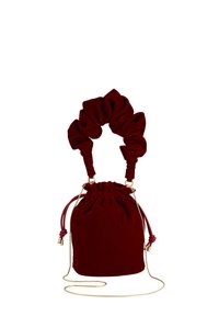 Red velvet drawstring bag with a scrunchie-style handle. Accented with gold hardware and a detachable shoulder strap. Smooth texture, soft silhouette.