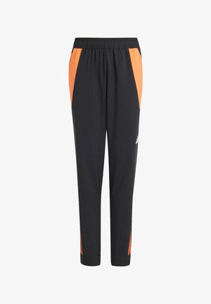 Pantaloni sportivi neri con dettagli arancioni ai lati, vita elasticizzata e gambe affusolate; realizzati in un materiale leggero e traspirante.