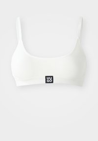 Hvit ribbet bralette med tynne stropper og en svart "HUGO" logo lapp på båndet. Mykt stoff gir en behagelig passform.