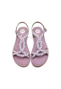 Sandali piatta viola con cinturini bianchi intrecciati e piccoli dettagli in argento. Presentano una soletta in suede e una fibbia alla caviglia regolabile.