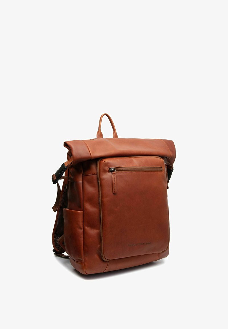 Mochila de cuero marrón con parte superior enrollada, bolsillo frontal con cremallera, bolsillos de malla laterales y correas ajustables, con una textura suave y un diseño minimalista.