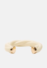 Skręcana kremowa bransoletka z błyszczącej żywicy, z gładkimi, złotego koloru okrągłymi akcentami na obu końcach, dla kontrastu.