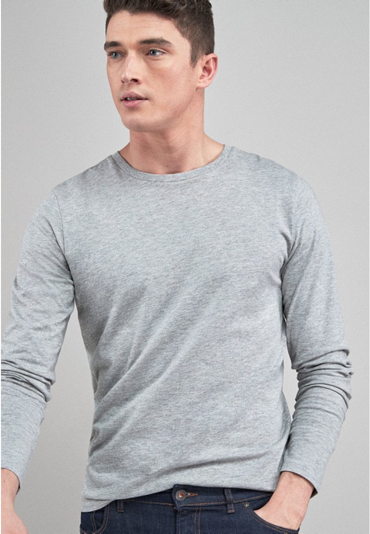 Langærmet grå T-shirt lavet af blød bomuld, med rund udskæring og en glat overflade. Matchet med mørke denim jeans.