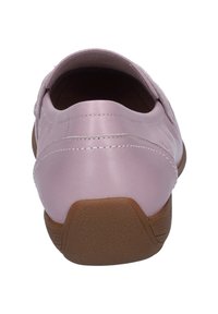 Light pink slip-on shoes with a smooth leather upper, subtle stitching details, and a textured brown rubber sole for grip.