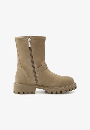 Tan suede ankle boot with a side zip closure, rugged rubber sole, rounded toe, and a strap detail across the midsection.