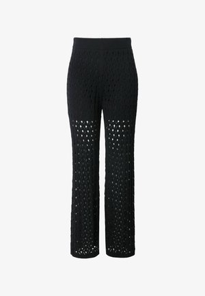 Pantalons en tricot noirs à coupe ample, présentant un design en tissage ouvert à motifs sur l'ensemble et une taille élastique confortable.