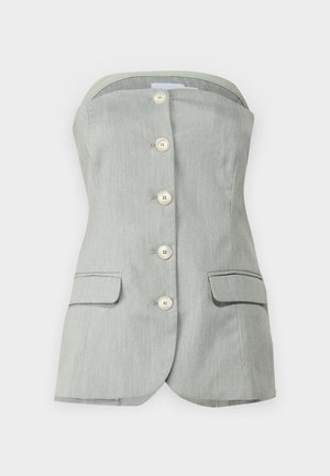 Grå axelbandslös topp med knäppning fram, prydd med sex stora vita knappar, två sidofickor och en strukturerad design. Texturerad fabrikfinish.