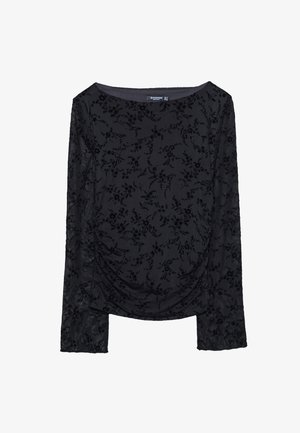 Črn dolg rokav vrh z žametno teksturo, okrašen s cvetličnim vzorcem. Okrogla izrez in nabran detajl na sprednji strani.