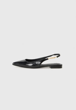 Black leather slingback shoe with a pointed toe, flat heel, and a gold-tone hardware accent on the strap. Smooth texture and sleek design.