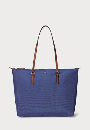 Navy blue tote bag featuring a textured fabric, brown faux leather straps, silver hardware, and a zip closure at the top.