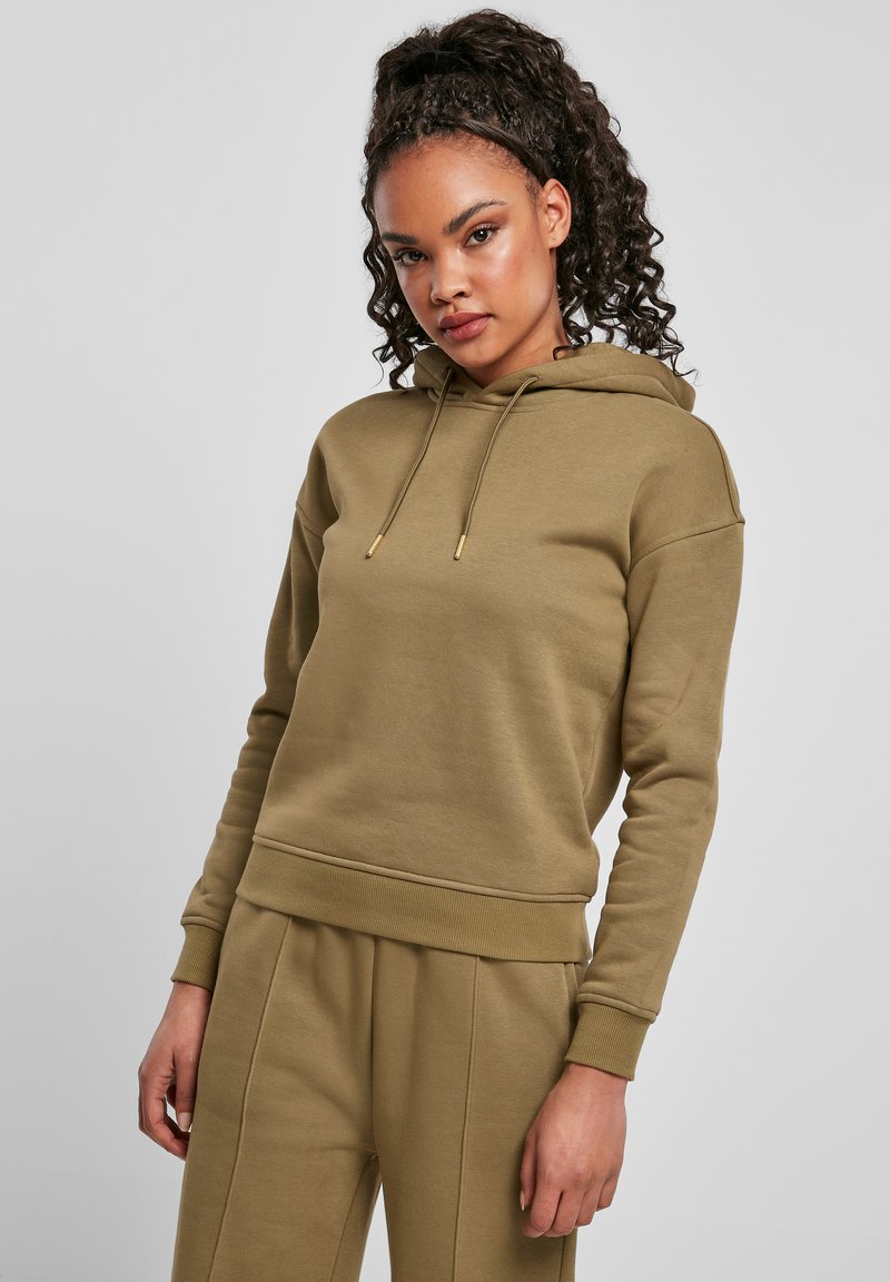 Felpa khaki con cappuccio, cordoncino, polsini e orlo a coste. Tessuto morbido con una vestibilità rilassata, abbinata a pantaloni coordinati.