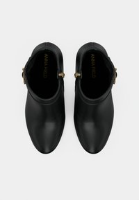 Μαύρες ankle μπότες με λεία υφή, μυτερή μύτη και μια πλευρική αγκράφα. Το εσωτερικό διαθέτει μαλακή επένδυση με λογότυπο της επωνυμίας.