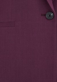 Fialový blazer vyrobený z texturované látky, s černým knoflíkem a boční kapsou. Design je přizpůsobený s čistými liniemi a elegantním provedením.