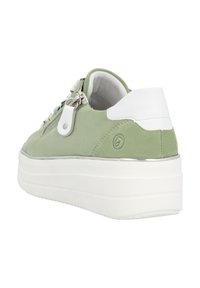 Green suede sneaker with a white heel, silver hardware, and a thick white sole. Features a zip closure and colorful lace accents.