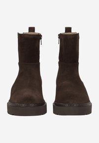 Brown suede ankle boots with a smooth texture, easy zip closure, raised ankle, and thick rubber soles for added traction.