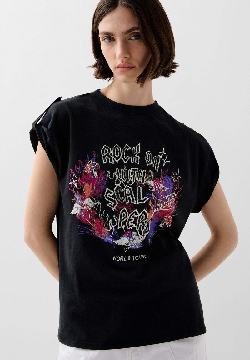Black cotton t-shirt featuring a colorful graphic design with text "ROCK ON with SCALPERS WORLD TOUR." Rolled sleeves and relaxed fit.