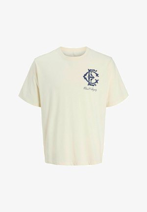 T-shirt en coton couleur crème avec des manches courtes. Présente un logo graphique bleu marine et le texte "Classe & Dignité" sur la poitrine gauche.