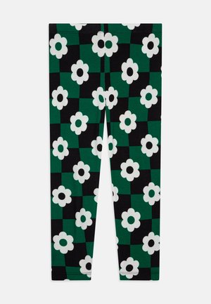 Leggings med et grønt og svart rutemønster med store hvite blomster. Laget av et elastisk stoff med en glatt tekstur.