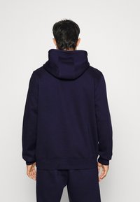 Fanatics MLB NEW YORK YANKEES ESSENTIALS CREST GRAPHIC HOODIE - Kapuutsiga pusa - navy