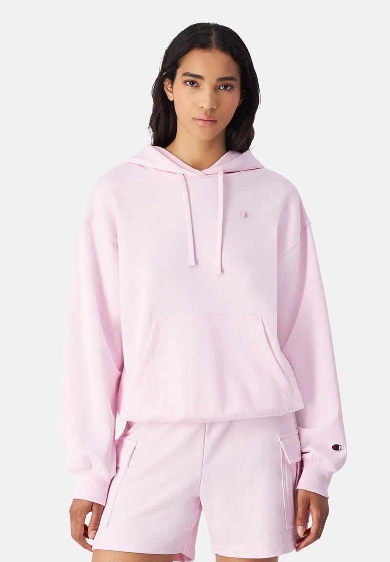 Felpa con cappuccio rosa, dotata di tasca frontale, vestibilità comoda e polsini a costine. Presenta un piccolo logo sul petto e una texture morbida.