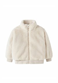 Kunstkarusnahast kreemjas jakk kõrge kraega, ees lukuga ja soonikkoes varrukate äärtega. Pehme tekstuur ja kerge disain, sobib kihiliseks kandmiseks.