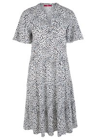 Kortärmad klänning i lätt tyg med ett mönster av leopardtryck i svart och marinblått på vit bakgrund, med en flerskiktskjol.