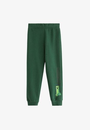 Zielone dresy z elastycznym pasem, ściągaczami u dołu i grafiką Creepera z gry Minecraft na lewej nodze. Miękka, teksturowana tkanina.