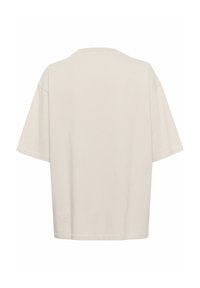 T-shirt à manches courtes, beige clair, avec une coupe décontractée, un col rond et un ourlet cousu ; texture en coton lisse, sans motifs ni accents visibles.