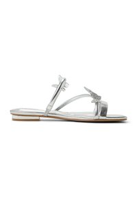 Silver metallic sandal with thin straps, butterfly accents, and a low, flat heel. Smooth texture and minimalist design.