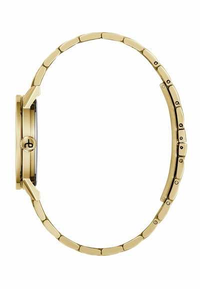 Vedere laterală a unui ceas subțire din aur, cu o brățară metalică legată și o coroană cu un mic logo.