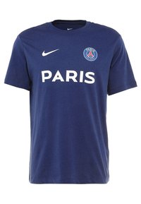 Námořnická modrá bavlněná tričko s krátkým rukávem, se znakem "PARIS" a logem PSG na přední straně. Měkká textura a kulatý výstřih.