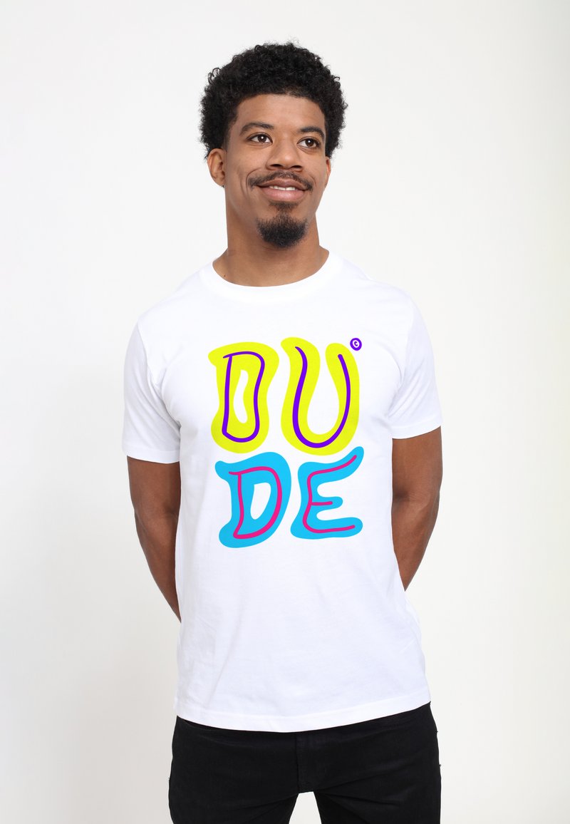 Bílý bavlněný tričko s výrazným, vícebarevným textem "DUDE" v žluté, růžové a modré barvě se hravým, vlnitým písmem. Krátké rukávy.