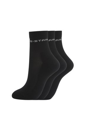 Three pairs of black ankle socks with ribbed cuffs and light gray text logo on each cuff.
